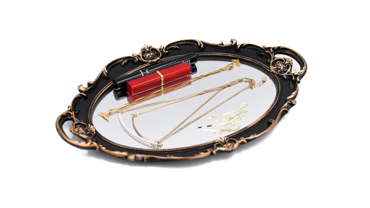Decorative mirror tray with gold edges, used for displaying candles, perfumes, or jewelry on a vanity or coffee table.