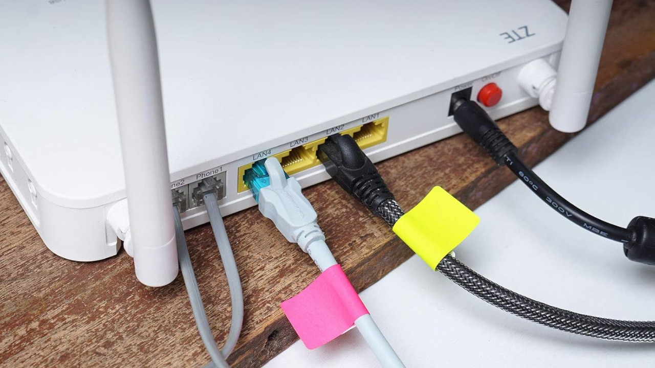 Pastel rectangular color-coded labels neatly stuck on various cords and cables to keep them organized.